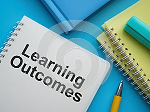 Notebooks, pen and document about Learning outcomes.