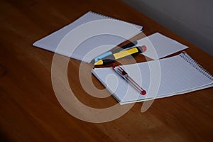 Notebooks And pens for hand written notes.