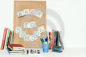 Notebooks piles, stack of books education back to school background, textbooks, glasses and pencils in holder with copy space for