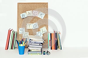 Notebooks piles, stack of books education back to school background, textbooks, glasses and pencils in holder with copy space for