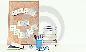 Notebooks piles, stack of books education back to school background, textbooks, glasses and pencils in holder with copy space for