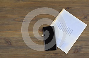 Notebooks, smartphone on a wooden table