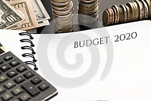 Notepad with Budget 2020 text, calculator and money