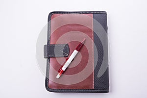 Notepad case with pen on the white background