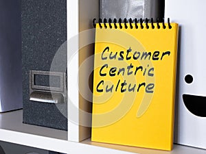 Notepad with an inscription Customer centric culture is on the shelf.