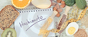 Notepad with inscription hashimoto, tape measure and best ingredients or products for healthy thyroid