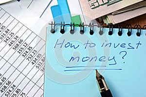 Notepad with inscription how to invest money