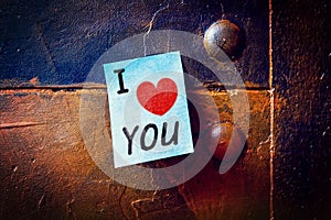Notepad on a metallic pinboard, Text i love you with a heart