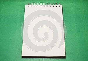 notepad for notes on a sheet of green paper isolated