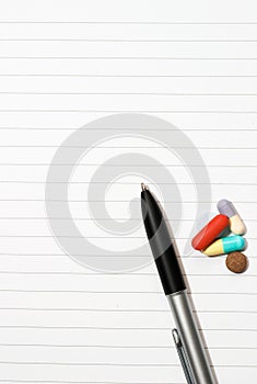 Notepad, one pen, pills