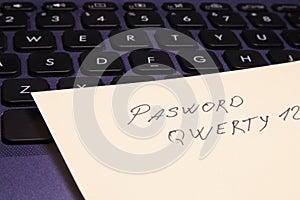 Notepad with password on computer keyboard close-up. Security of information that is password protected. Soft focus