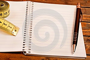 Notepad with pen and centimeter