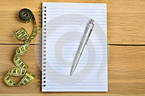 Notepad with pen and centimeter