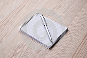 Notepad with pen on office wooden table