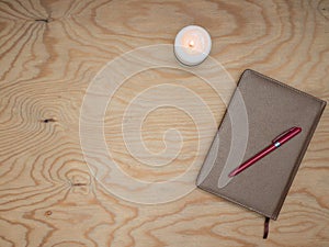 Notepad with a pen on a wooden table. photo