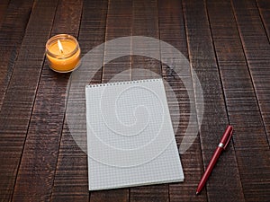 Notepad with a pen on a wooden table. photo