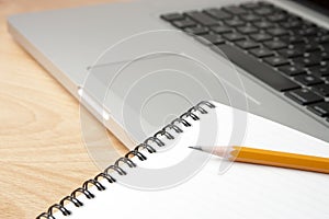 Notepad Pencil and Computer Laptop