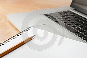 Notepad Pencil and Computer Laptop