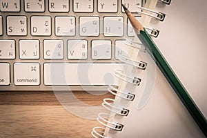 Notepad Pencil and Computer Laptop