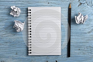 Notepad with pencil and crumpled papers