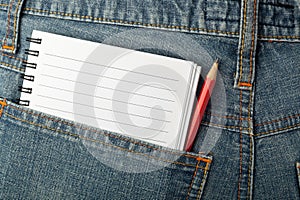 Notepad and pencil in jeans pocket