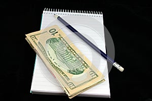 Notepad Pencil and Money