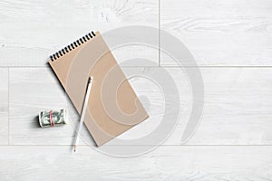 Notepad, pencil and money