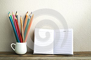 Notepad with pencil on wood board background.using wallpaper for education, business photo.Take note of the product for book with