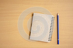 Notepad with pencil on wood board background.using wallpaper for education, business photo.Take note