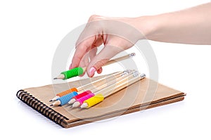 Notepad and pencils in hand