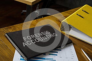 Notepad with phrase forensic accounting, folder and papers.