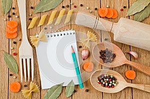 Notepad for recipes, pencil and decorative frame from kitchen tools, pasta and spices