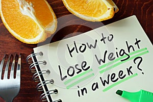 Notepad with sign how to lose weight in a week.