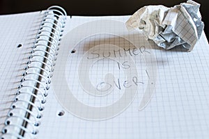 A notepad with squares and a pencil. Written on the sheet, the p