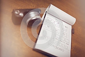 Notepad with storyboard and digital camera