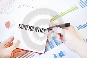 Notepad with text confidential. Diagram and white background