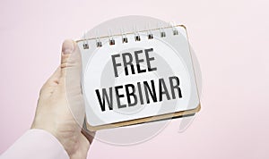 Notepad with text Free Webinar with pink