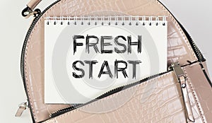 Notepad with text FRESH START. A notebook peeks