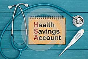 Notepad with text Health Savings Account HSA and stethoscope photo