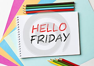 The Notepad with the text Hello Friday is on colored paper with color pencils