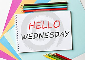 The Notepad with the text Hello Wenesday is on colored paper with color pencils