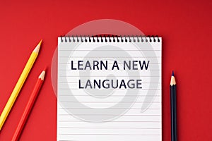 Notepad with text Learn a New Language