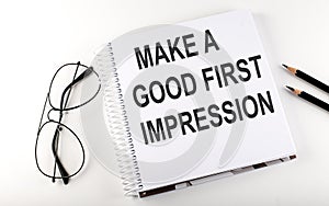 Notepad with text MAKE A GOOD FIRST IMPRESSION . White background. Business concept