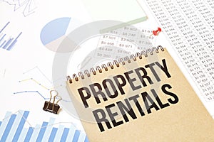 Notepad with text PROPERTY RENTALS. Diagram and white background