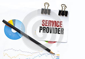 Notepad with text SERVICE PROVIDER on business charts and pen