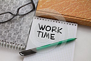 Notepad with text Work Time with another notepad pen and eyeglasses