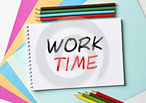 The Notepad with the text Work Time is on colored paper with color pencils