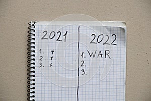 Notepad with the text of the year 2021 and 2022. Plans for the year 2022 war in Ukraine. All forces to win the war
