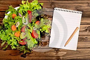 Notepad and vegetable salad