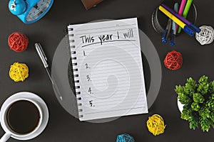 Notepad with wish list and coffee cup. New year hope and resolution concept. photo